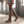 Woman walking through a sunlit warehouse in the Marlene brown suede knee high boots