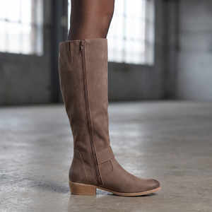 Close view of the Marlene boot inside zip, ankle strap buckle and low block heel on concrete