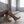 Marlene brown suede knee high boots on a woman seated on a concrete step