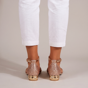 Martina low block heel sandals in Rose Gold seen from behind on a light gray studio backdrop