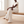 Woman seated on a wooden bench in White Nadine wide leg pants