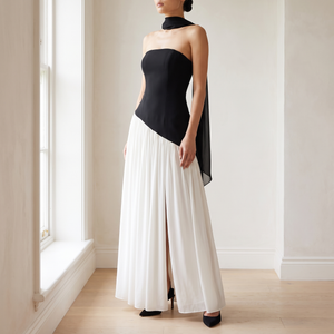 Ondine strapless maxi gown in Black and White by a window in a bright room with plaster walls