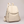 Pauline leather backpack in Beige standing upright on a light gray studio backdrop