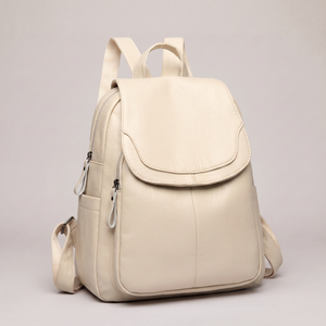 Pauline leather backpack in Beige standing upright on a light gray studio backdrop