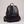 Pauline leather backpack in Black standing upright on a light gray studio backdrop