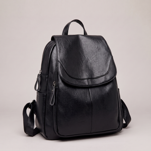 Pauline leather backpack in Black standing upright on a light gray studio backdrop