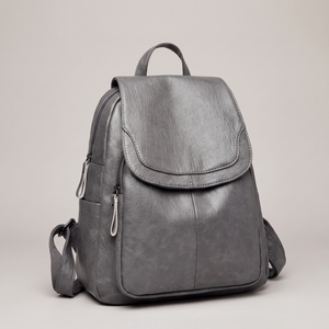 Pauline leather backpack in Gray standing upright on a light gray studio backdrop