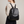 Pauline leather backpack in Black worn on both shoulders, light gray studio backdrop
