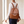 Pauline leather backpack in Cognac carried on both shoulders past a window
