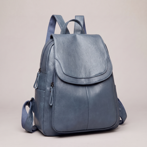Pauline leather backpack in Light Blue standing upright on a light gray studio backdrop