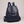 Pauline leather backpack in Navy Blue standing upright on a light gray studio backdrop