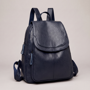 Pauline leather backpack in Navy Blue standing upright on a light gray studio backdrop