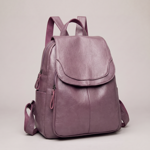 Pauline leather backpack in Purple standing upright on a light gray studio backdrop