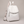 Pauline leather backpack in White standing upright on a light gray studio backdrop