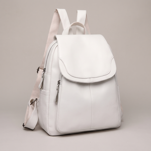 Pauline leather backpack in White standing upright on a light gray studio backdrop