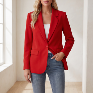 Perrine single button blazer in Red, standing by a window in a bright room