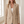 Perrine single button blazer in Beige, close detail of the lapels, button and flap pocket in a bright room