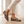 Close view of the Portia leopard print loafers showing the pointed toe and gold horsebit, worn with cream cropped trousers