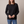 Rita raglan crew neck sweatshirt in Black on a light gray studio backdrop
