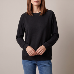 Rita raglan crew neck sweatshirt in Black on a light gray studio backdrop