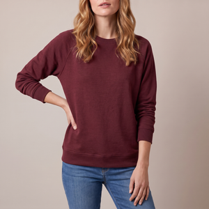 Rita raglan crew neck sweatshirt in Burgundy on a light gray studio backdrop