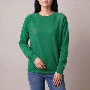 Rita raglan crew neck sweatshirt in Green on a light gray studio backdrop