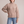 Romane chunky knit turtleneck sweater in Beige with jeans on a light gray studio backdrop