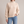 Romane chunky knit turtleneck sweater in White with jeans on a light gray studio backdrop