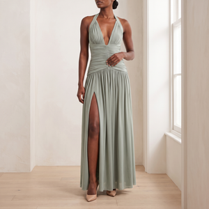 Rosalyn halter maxi dress in Sage Green worn by a window in a bright room