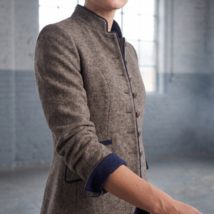 Close view of the Rosamund blazer stand collar, bronze tone buttons and navy turned back cuff