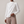 Solange draped mock neck blouse in White on a light gray studio backdrop