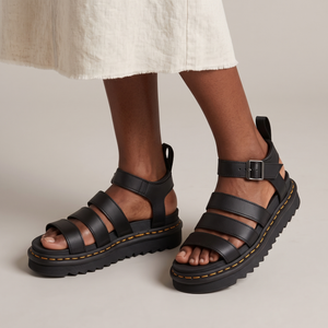 Soledad platform sandals in Black worn with an ecru linen midi skirt on a light gray studio backdrop