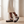 Soledad platform sandals in White worn by a window in a bright room with a pale oak floor