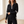 Close view of the half zip collar and striped sleeves of the Suzanne knit set in Black