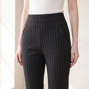 Close view of the wide pull on waistband and slanted pocket on the Sylvia pants in Black Stripe
