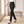 Sylvia high waist dress pants in Black Stripe, walking across a bright room