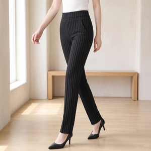 Sylvia high waist dress pants in Black Stripe, walking across a bright room