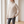 Verity lattice knit turtleneck sweater in Beige worn relaxed by a window
