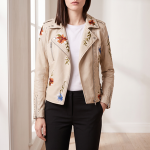 Victoire embroidered leather moto jacket in Cream worn open by a window