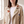 Close view of the floral embroidery, snap studs and zip pocket on the Victoire embroidered leather moto jacket in Cream