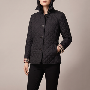 Winona quilted jacket in Black on a light gray studio backdrop