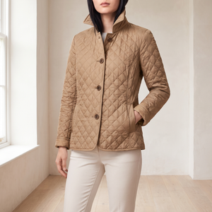 Winona quilted jacket in Khaki by a window in a bright room