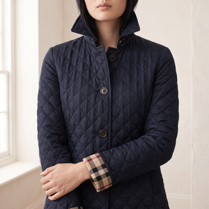 Close view of the pointed collar, buttons and check lined cuff on the Winona jacket in Navy Blue