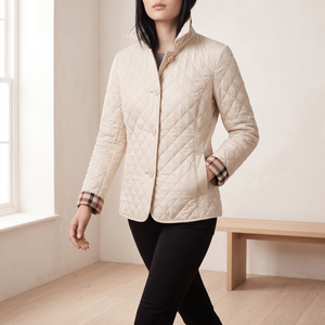 Winona quilted jacket in Cream, walking across a bright room